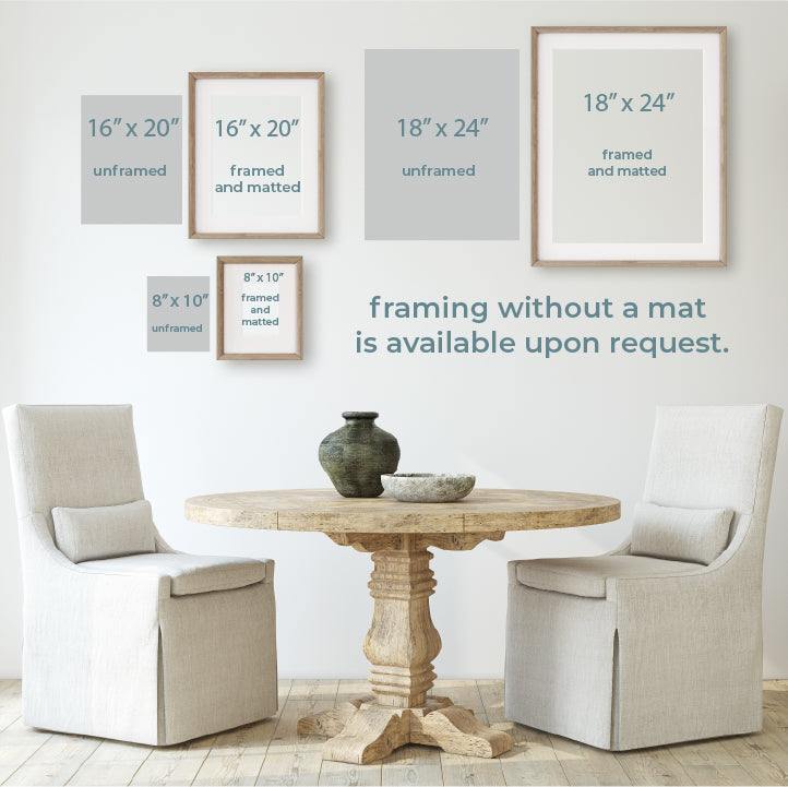 a table with two chairs and a vase on it