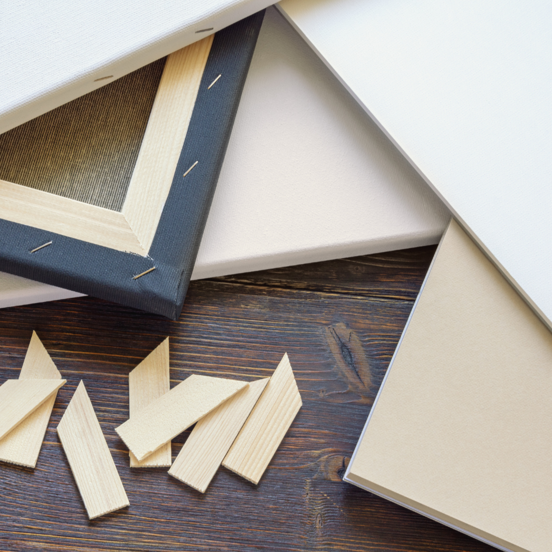 Wooden picture frames and wooden pieces on a wooden surface